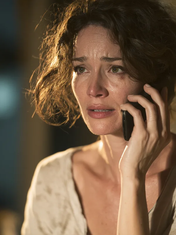American mother relieved after a phone call, representing emergency borrowing guidance from our editors